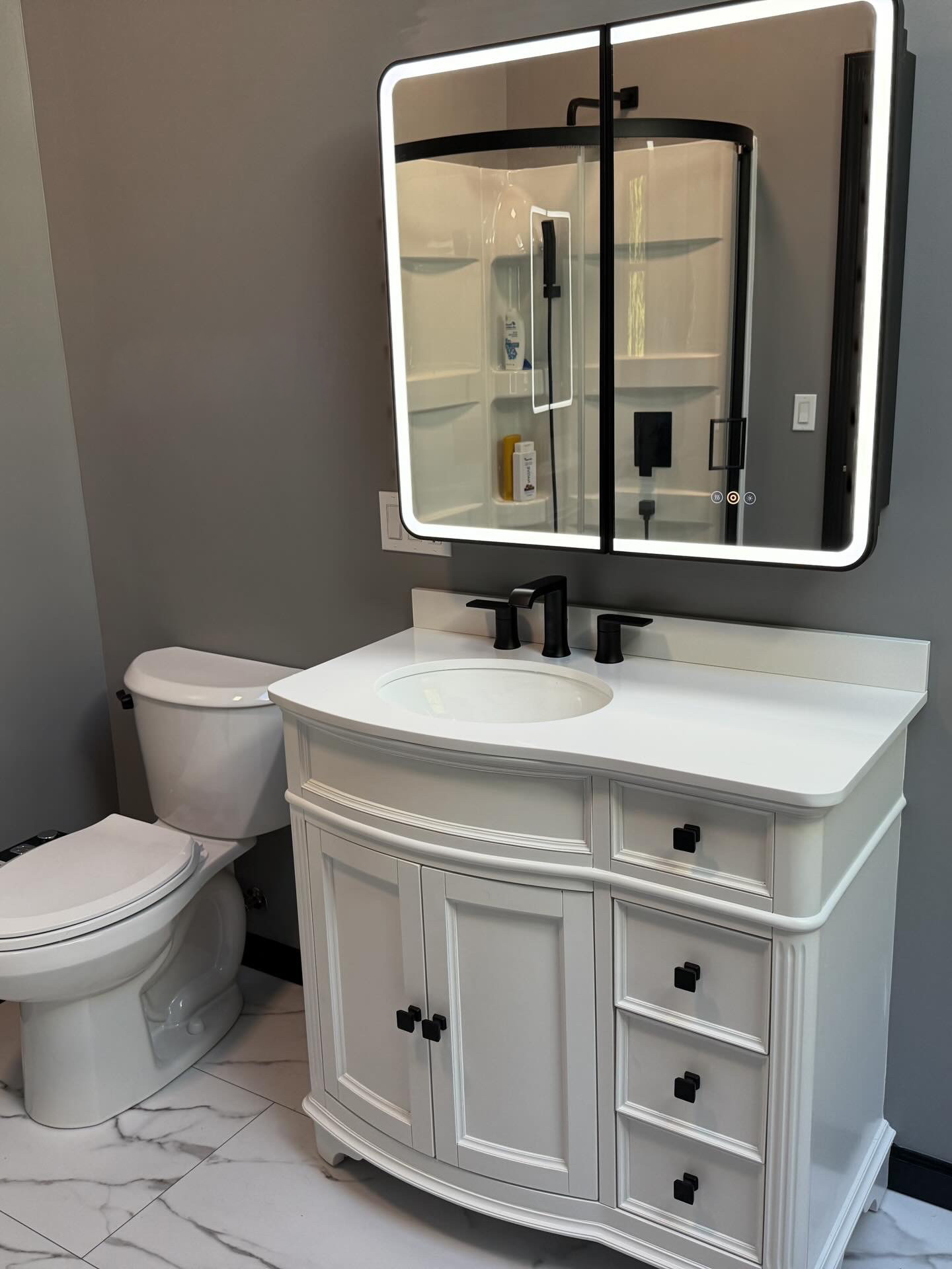 Modern bathroom with tiled walk-in shower and custom vanity