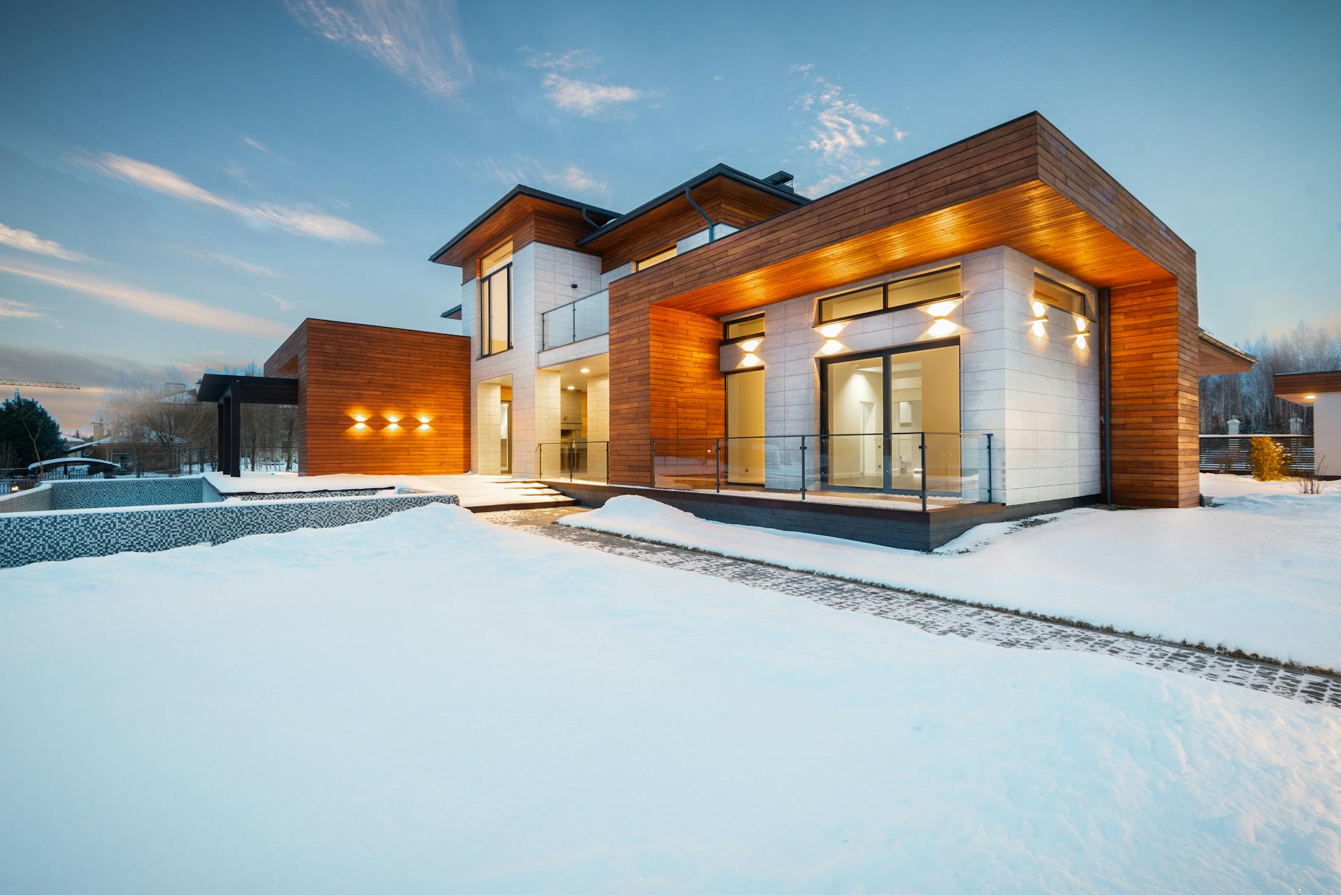 Two-story home exterior after new double-hung window installation throughout