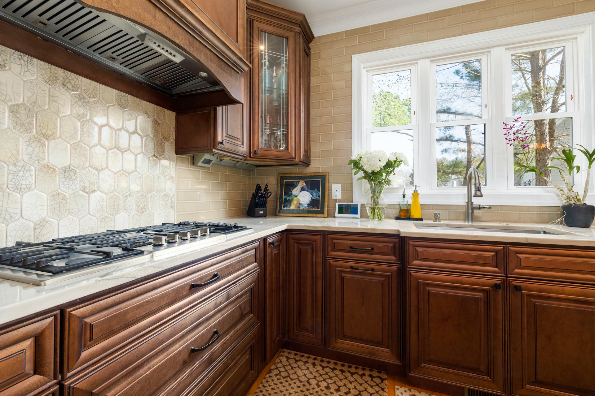 Completed kitchen remodel with white shaker cabinets, quartz countertops, and subway tile backsplash