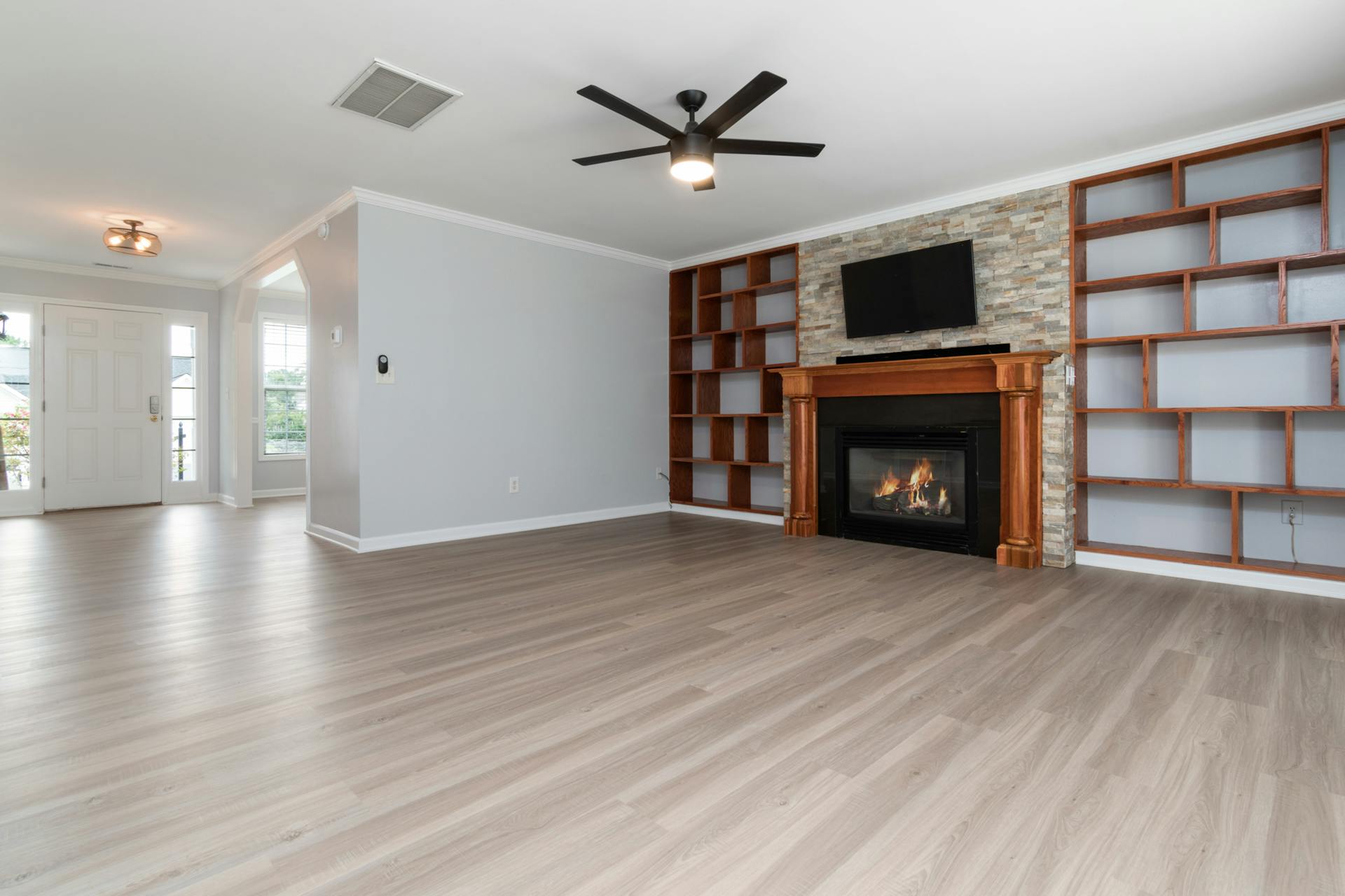 Finished living room with hardwood floors and built-in cabinetry